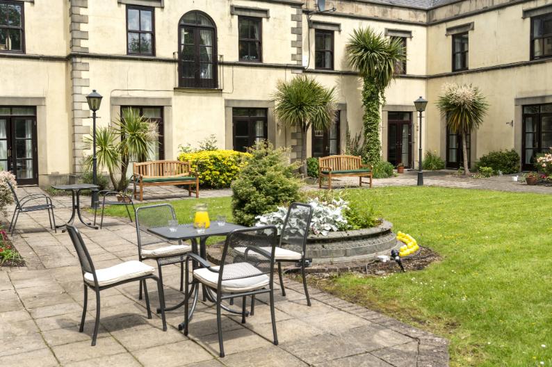 garden chairs around a table outside